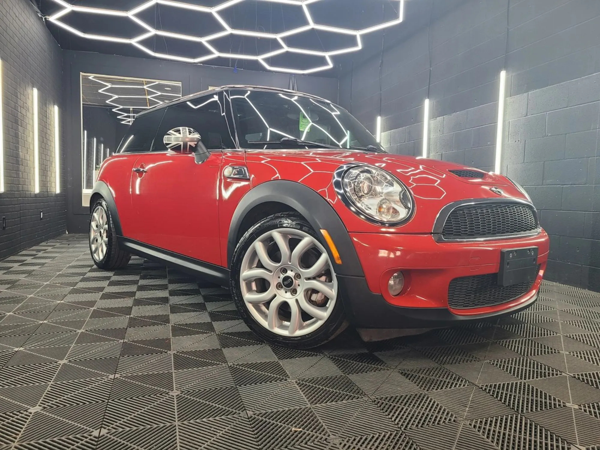 Red MINI Cooper under studio lighting at Alpha Detailing