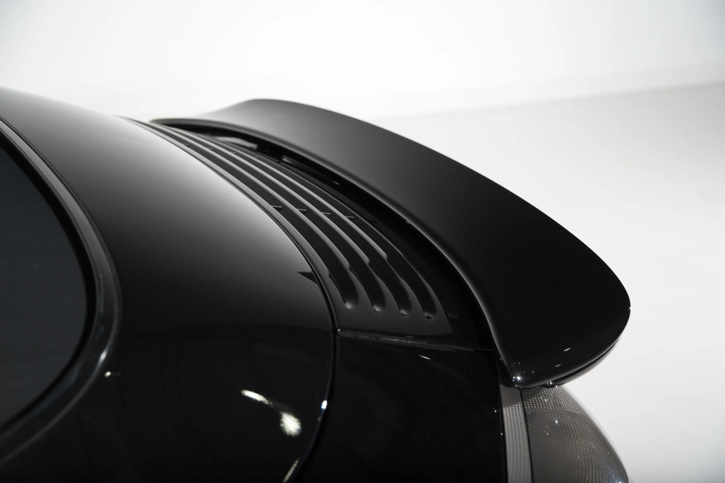 Close-up of polished black luxury vehicle paint after Icon Rocklear