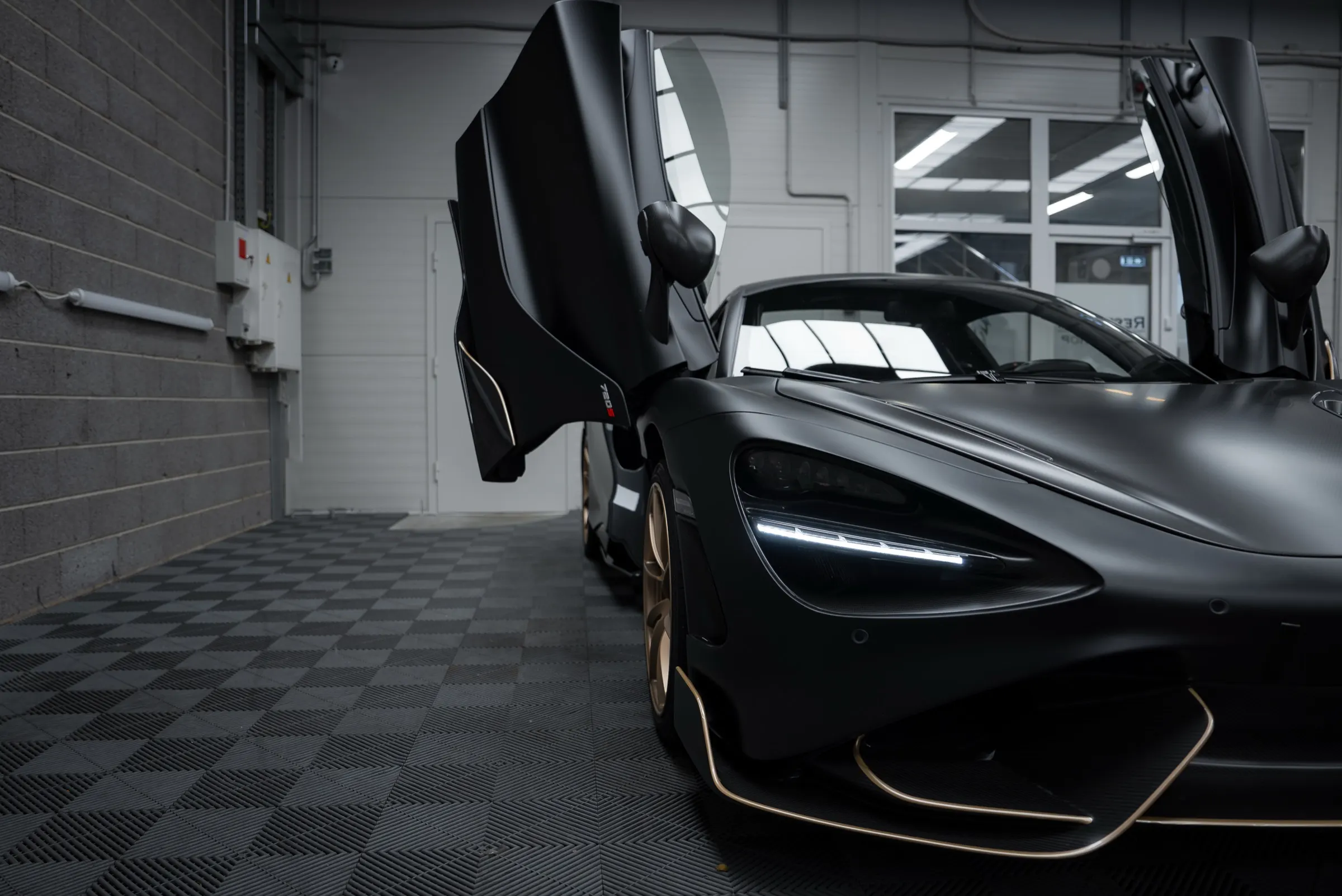 Matte black supercar in detailing studio